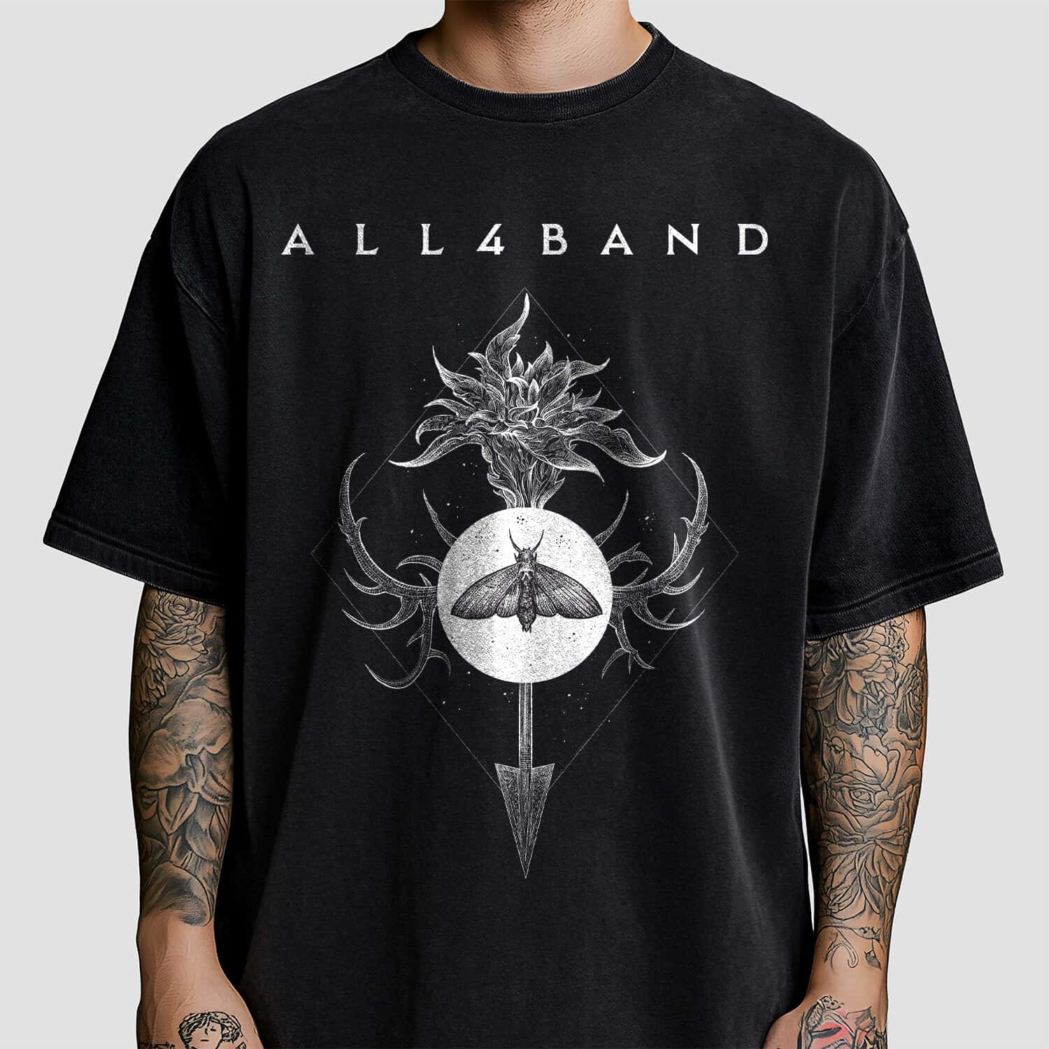 Band shirt design featuring a symbolic composition with a moth, arrow, and a flower inside a diamond frame
