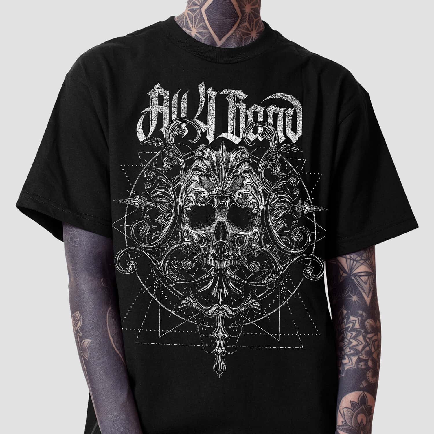 Black and white metal band shirt design featuring an ornate skull, baroque flourishes, and geometric patterns