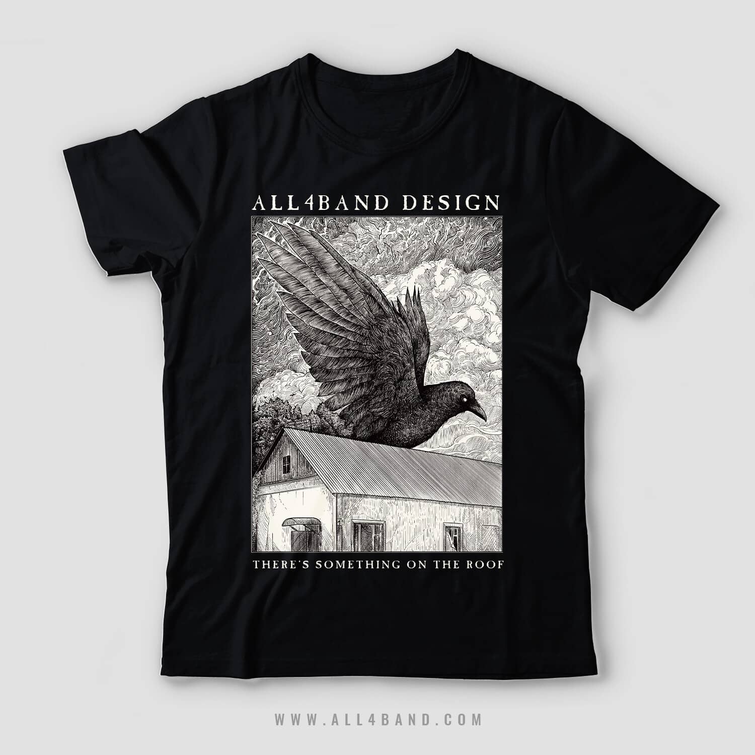 Detailed black and white shirt design featuring a giant raven flying over a rural house beneath dense swirling clouds.